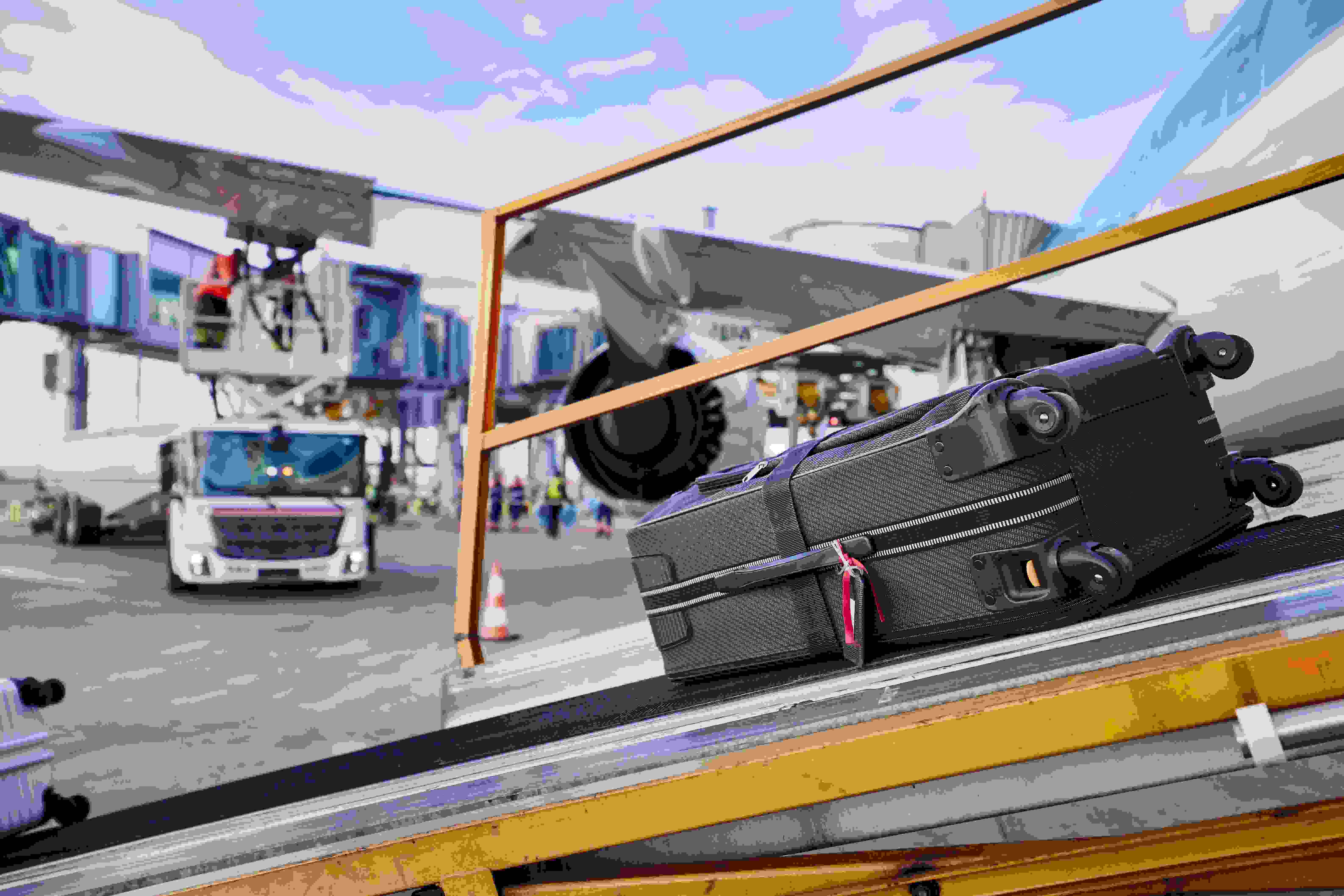 Airport baggage handling with luggage on a belt loader